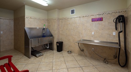 Tiled dog wash room with large bathing sink and drying counter