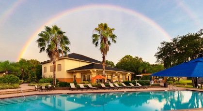 Swimming pool with lounge seating and umbrellas