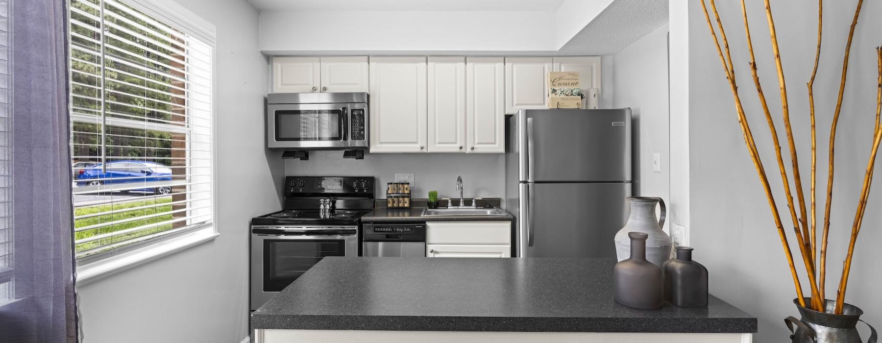 a kitchen with a black countertop