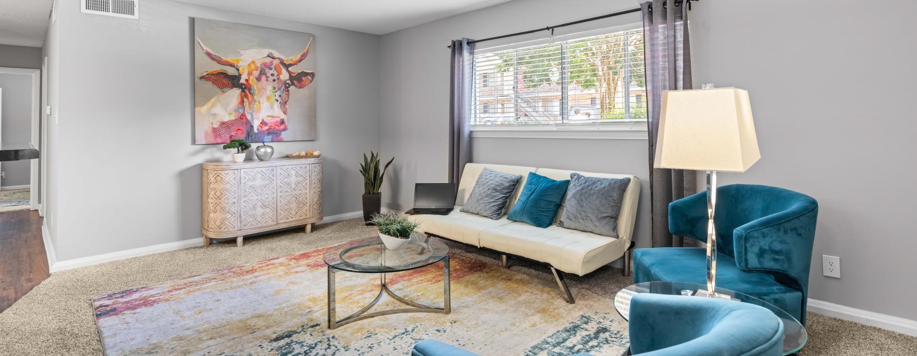 a living room with a couch and chairs