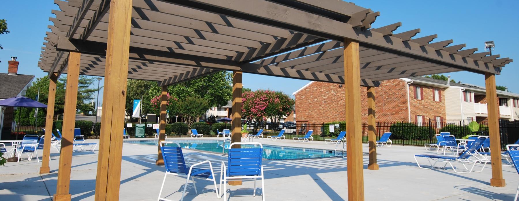 a covered area with chairs and umbrellas