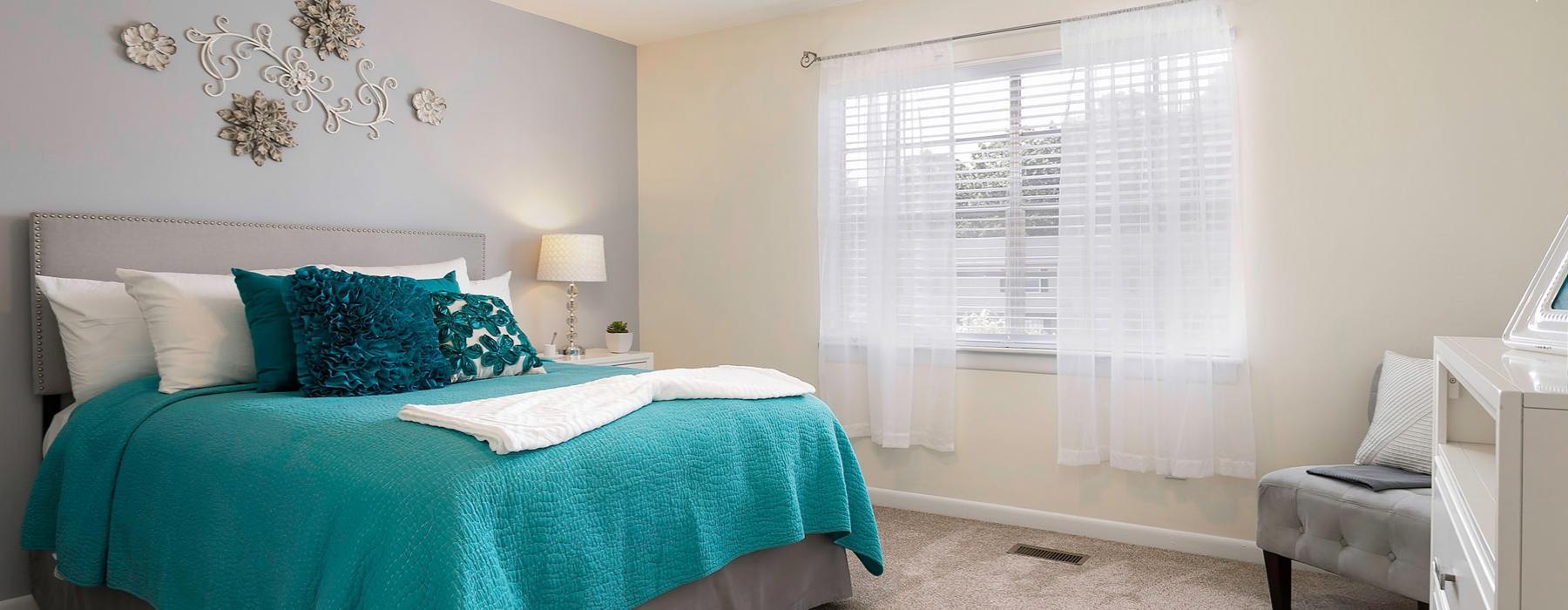 a bedroom with a bed and a chair