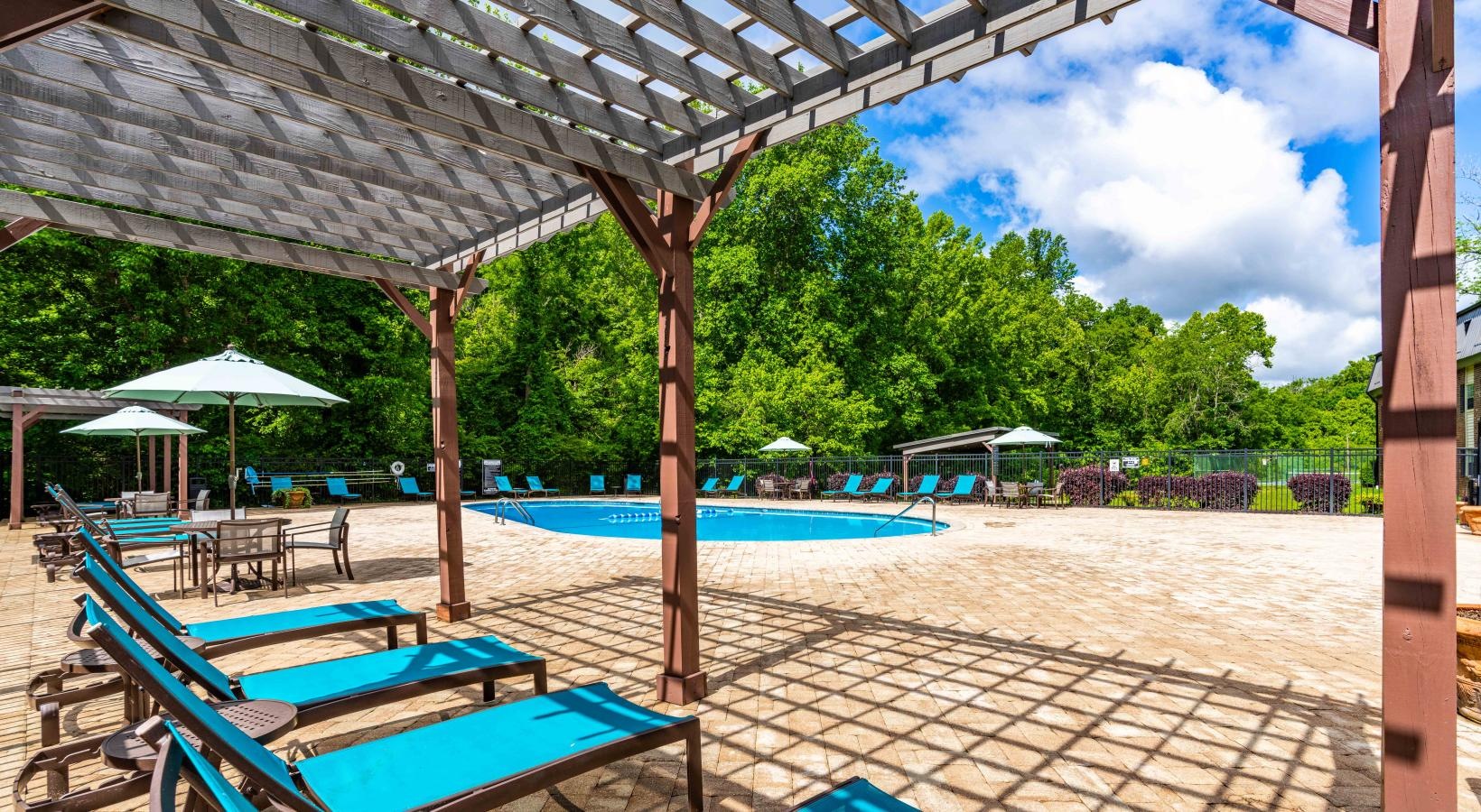 Swimming pool with lounge seating and umbrellas