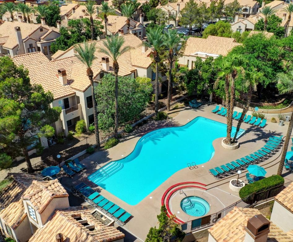 a swimming pool surrounded by trees and buildings