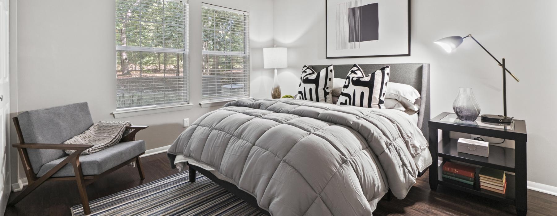 a bedroom with a bed and a chair