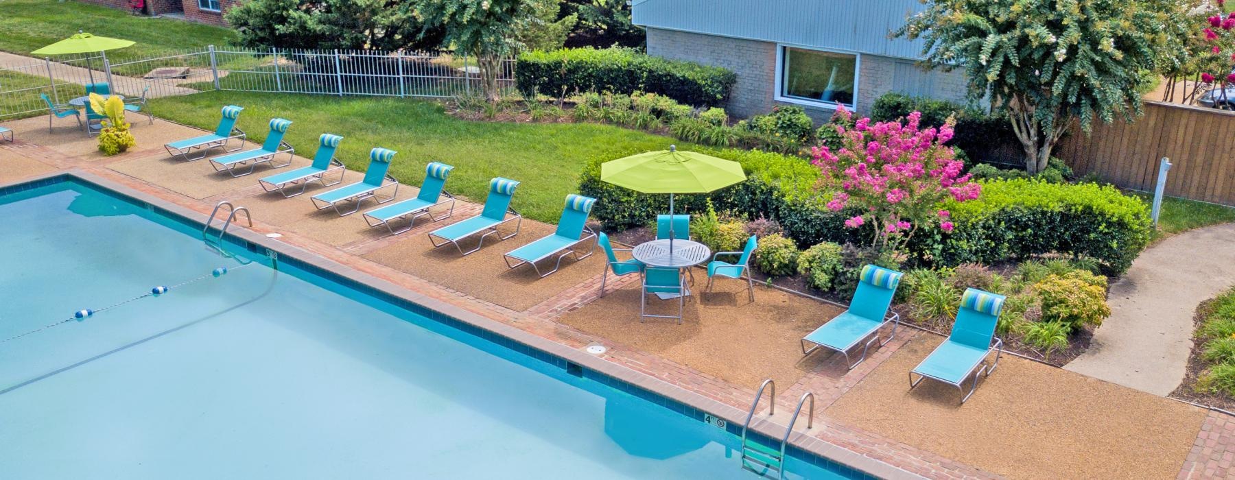a pool with chairs and umbrellas