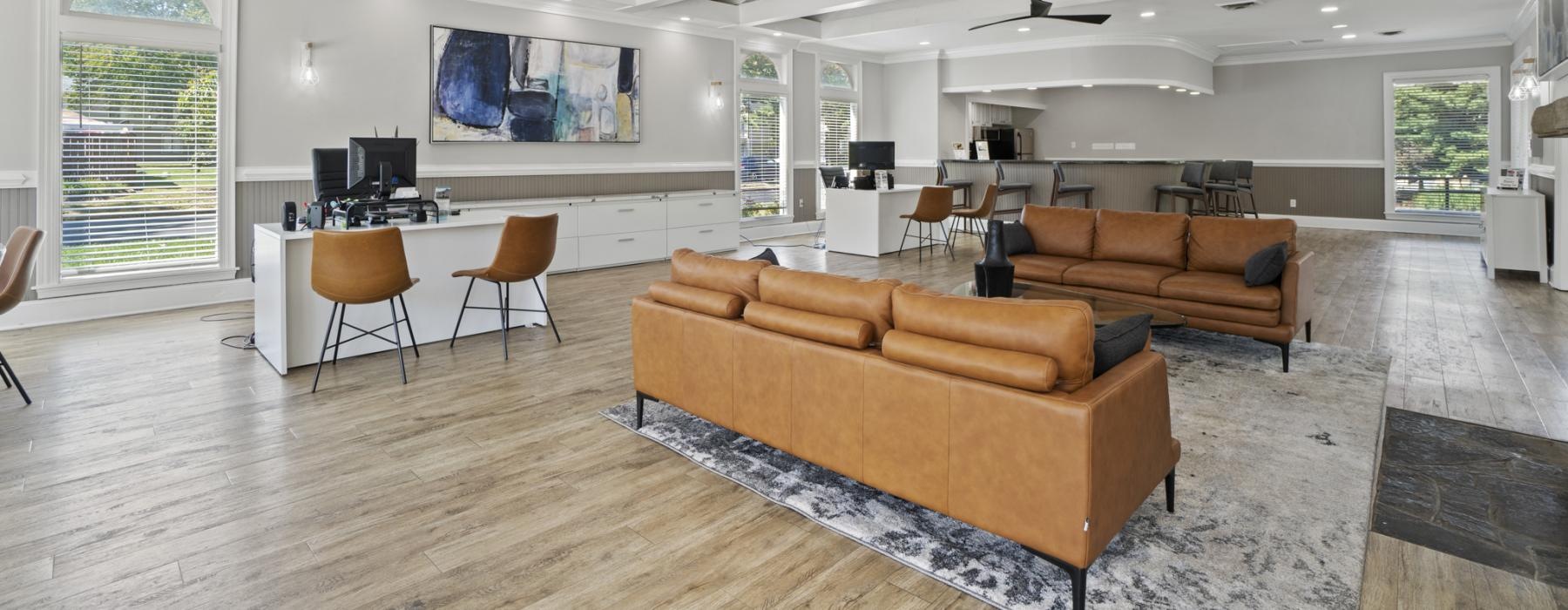 a large lounge room with a wood floor and couches