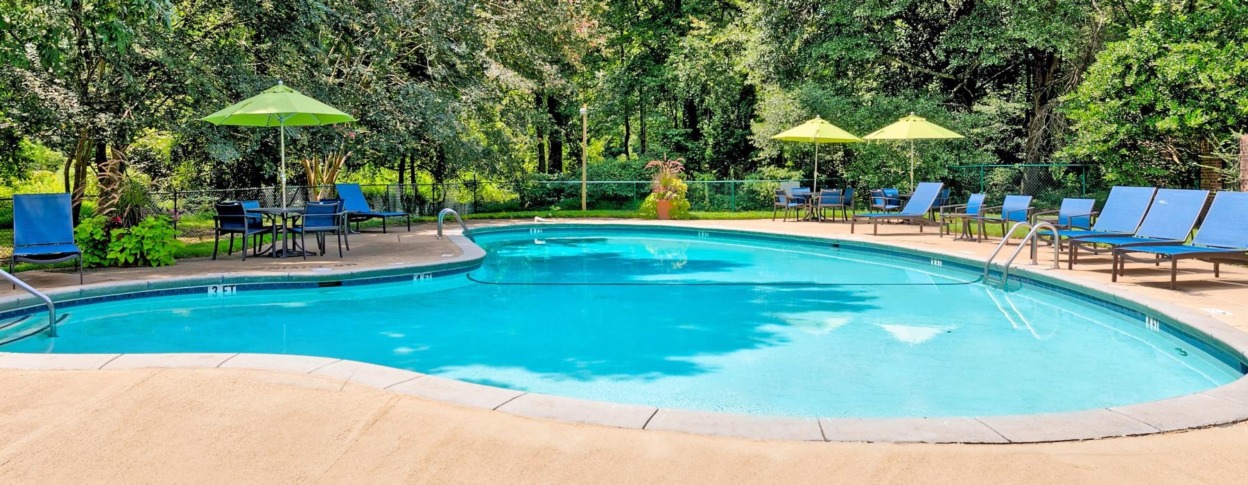 a pool with chairs and umbrellas