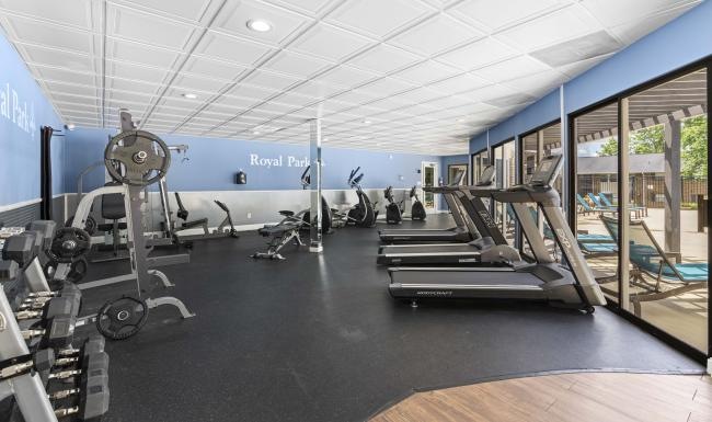 a room with exercise equipment and a large window