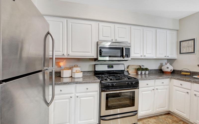 a kitchen with white cabinets
