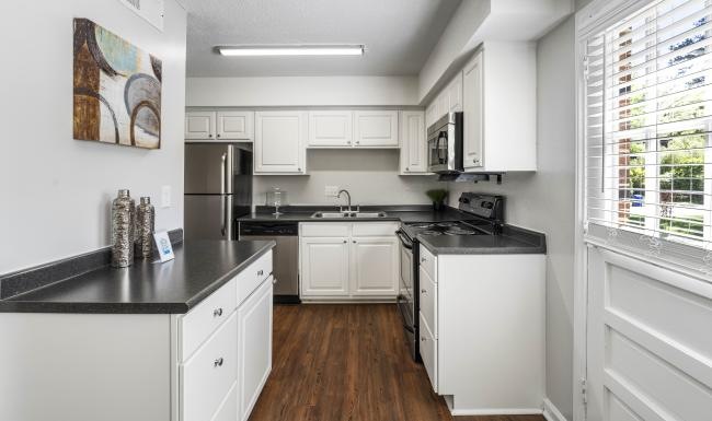 a kitchen with white cabinets