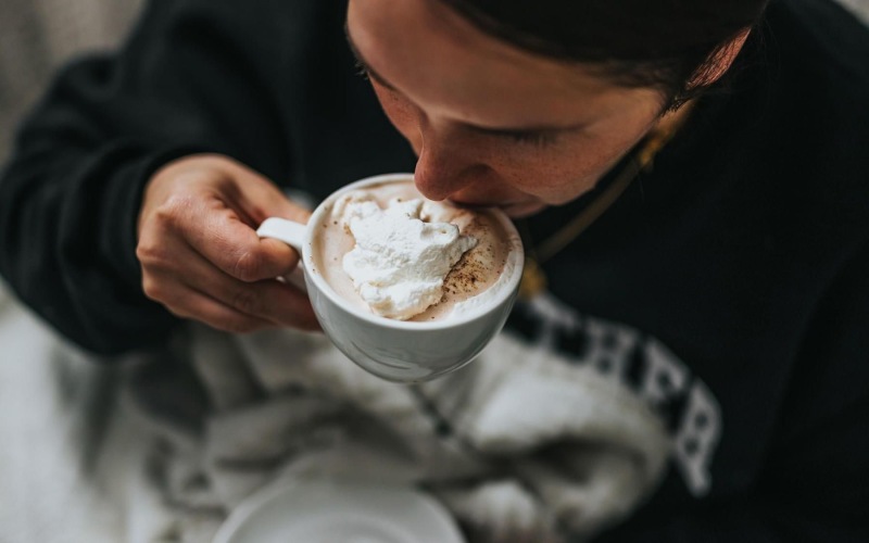 man sipping a hot beverage