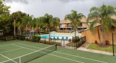 Tennis court is next to the pool