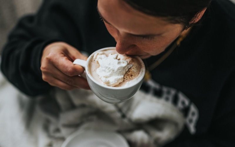 man sipping a hot beverage